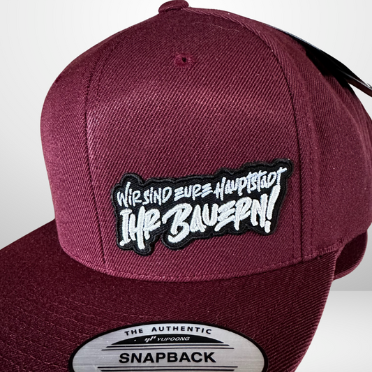Limited Drop: "Wir sind eure Hauptstadt, ihr Bauern!" Snapback Cap